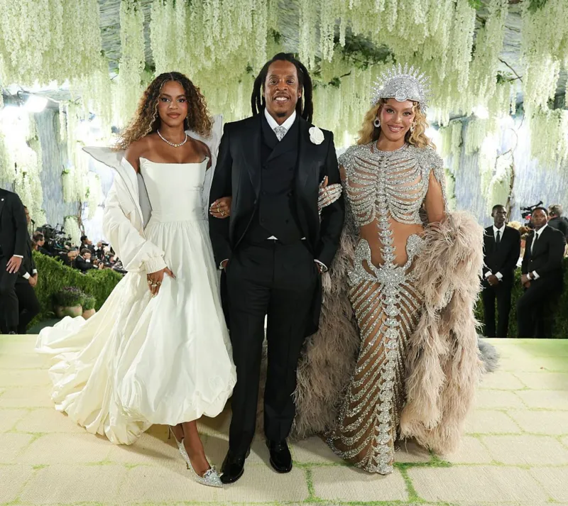 Met Gala 2026: Bold “Costume Art” Looks Steal the Spotlight The 2026 Met Gala once again proved why it is known as fashion’s biggest night. This year’s theme, “costume art,” pushed celebrities to go beyond traditional red carpet style and embrace creativity, drama, and storytelling through fashion. Held in support of the Metropolitan Museum of Art’s Costume Institute, the annual event brought together global stars, designers, and artists. The red carpet turned into a stage where imagination met high fashion. A Dramatic Opening on the Red Carpet Broadway performer Joshua Henry set the tone for the night. He delivered a live performance of the iconic song I Wanna Dance With Somebody, joined by dancers and a full band. The Met steps were transformed into a lush garden scene with moss-like details, adding a theatrical touch right from the start. Star-Studded Guest List and Hosts This year’s co-chairs included global icons like Beyoncé, Nicole Kidman, Venus Williams, and Anna Wintour. Their presence added prestige and influence to an already high-profile event. Celebrities such as Madonna, Sabrina Carpenter, Naomi Osaka, and Angela Bassett also walked the carpet, each bringing their own interpretation of the theme. Fashion That Pushed Boundaries Some stars fully committed to the “costume art” concept. Bad Bunny, Heidi Klum, and Katy Perry stunned fans with bold transformations. Their outfits blurred the line between fashion and performance art, making them almost unrecognisable. Beyoncé’s Grand Comeback After a decade-long absence, Beyoncé returned to the Met Gala in unforgettable style. She wore a striking gown designed by Olivier Rousteing. The outfit featured an intricate skeleton design and a dramatic feathered cape, perfectly matching the theme. She attended the event with her husband, Jay-Z, and their daughter, Blue Ivy Carter. At just 14, Blue Ivy became one of the youngest guests, drawing attention for her appearance alongside her parents. Beyoncé shared that she felt happy to return and enjoy the moment with her family, making her comeback even more special.