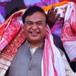 Himanta Biswa Sarma Begins Second Term as Assam Chief Minister Election Victory in Assam Himanta Biswa Sarma has been sworn in again as chief minister of Assam after a strong win for the ruling party. Bharatiya Janata Party won 82 out of 126 seats in the state assembly election. Its partners secured 20 more seats, giving the alliance a clear majority. The party has stayed in power since 2016 and continues to strengthen its position in the region. Political Journey and Rise Sarma represents the Jalukbari constituency near Guwahati, Assam’s largest city. He has held this seat since 2001. He began his political career in the Congress party and worked as a minister under former chief minister Tarun Gogoi. Later, he switched to the Bharatiya Janata Party in 2015. His move brought several supporters with him and weakened the Congress party in Assam. His shift also helped the BJP expand quickly in the region. Role in BJP Expansion in Northeast India Sarma played a major role in building the BJP’s presence across northeast India. The party once had limited support in Assam, with a low vote share for many years. Over time, its support grew significantly and now stands much higher than before. He worked closely with local groups and helped the party form alliances in nearby states. His organizational skills made him an important figure in the party’s regional strategy. Governance and Welfare Programs During his leadership, the state government focused on infrastructure development such as roads and bridges. One of the key welfare schemes is Orunodoi, which provides financial support to women from low income families. Supporters say this program has helped many households across Assam. His administration has also focused on public services and development projects. Criticism and Political Debate Sarma’s leadership has also faced criticism. Opposition parties and rights groups accuse the government of targeting minority communities, especially Bengali speaking Muslims. Issues such as migration, identity, and citizenship remain sensitive in Assam politics. Some policies linked to religious schools and child marriage have sparked public debate. A recent AI generated video shared by the state party unit also triggered controversy before being removed.
