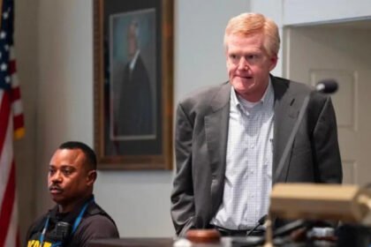 A South Carolina court has overturned the murder conviction of former lawyer Alex Murdaugh. He was convicted in 2023 for killing his wife Maggie and son Paul. The state Supreme Court has now ordered a new trial. Court decision The South Carolina Supreme Court issued a unanimous ruling, 5 to 0, in favor of a new trial. The judges said Murdaugh did not receive a fair trial because of outside influence on the jury. Murdaugh is currently serving two life sentences for the murders. He is also serving additional prison terms for financial crimes at both state and federal level. Reason for new trial The court found that the Colleton County Clerk of Court, Rebecca Hill, improperly influenced the jury. The judges said her actions affected the fairness of the trial. Hill has already pleaded guilty to misconduct, obstruction of justice, and perjury. She admitted to sharing sealed information and misusing public funds. Claims of jury influence The ruling included statements from jurors who said Hill made comments during the trial. One juror said she was told to watch Murdaugh closely, which affected how she viewed the case. Other jurors reported being told not to trust the defense and to avoid being misled by evidence presented in court. Some also said Hill suggested the case should not take long during deliberations. Background of the case Murdaugh was once a powerful attorney in South Carolina. His criminal trial lasted six weeks and received global attention. The case involved the shooting deaths of his wife and son near the family property. After his conviction, the case became widely covered through documentaries, podcasts, and books. The trial was also broadcast publicly. Hill later published a book about the case, but it was later withdrawn after plagiarism concerns.