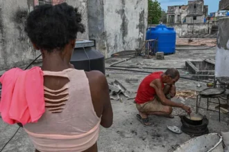 fe The crisis has been driven by a severe lack of diesel and fuel oil, which are essential for electricity generation. Reports indicate the country’s power system is under extreme pressure, with hospitals struggling to operate normally and many schools and government offices shutting down. Tourism, one of Cuba’s key income sources, has also been heavily disrupted. Recent reporting shows parts of Havana and other regions have experienced extremely long power cuts, in some cases lasting most of the day, as the national grid weakens further. Tensions over fuel supply and sanctions Cuban officials argue that US restrictions on fuel imports are the main reason for the shortage. They say these measures have reduced or stopped shipments from traditional suppliers such as Venezuela and Mexico. US officials, however, have defended their policy, saying the economic pressure is linked to broader political conditions and governance issues in Havana. Washington has also renewed its aid offer while maintaining criticism of Cuba’s leadership. Rare protests highlight public frustration The worsening situation has triggered rare street protests in Havana and other cities. Residents have demonstrated against prolonged blackouts, with growing anger over food spoilage, lack of electricity, and disruptions to essential services. Key point Cuba is now balancing between accepting external assistance and managing a deepening energy emergency that is already affecting healthcare, education, and public order.