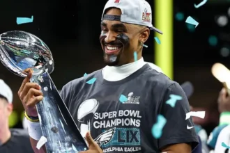 Eagles Set for London Game in 2026 NFL Season as League Expands Globally Philadelphia Eagles Head to London The Philadelphia Eagles will return to London in the 2026 NFL season. They will be part of a major international schedule that includes a record number of games outside the United States. The Eagles last played in London in 2018. The game in London will take place at Tottenham Hotspur Stadium. It adds to the league plan of growing American football across global markets. NFL Expands to Nine International Games The NFL will stage nine regular season games across four continents in 2026. These matches will be played in seven different countries. The United Kingdom will host three games again. The league is also expanding into new regions. Australia and France will host NFL games for the first time. This marks a major step in the sport’s international growth. Jaguars and 49ers Lead Overseas Schedule The Jacksonville Jaguars and San Francisco 49ers will each play two games outside the United States. The Jaguars will also host games in London across two consecutive weeks. The 49ers will take part in international fixtures that include matches in Mexico. The Baltimore Ravens and Dallas Cowboys will also play in Brazil in the league’s first game in Rio de Janeiro. London Games Schedule London will open its NFL run on 4 October. The Washington Commanders will face the Indianapolis Colts at Tottenham Hotspur Stadium. The Jaguars will then host the Eagles the following week at the same venue. After that, they will meet the Houston Texans at Wembley Stadium. This will be a divisional game, which is rare outside the United States. Games Across Europe and Australia The NFL will also stage games in other major cities. Paris will host its first NFL game at Stade de France, where the New Orleans Saints will meet the Pittsburgh Steelers. Real Madrid’s stadium will host a game between the Cincinnati Bengals and Atlanta Falcons. Munich will see the New England Patriots face the Detroit Lions. The opening international game of the season will be played in Australia. The Los Angeles Rams will face the San Francisco 49ers at the Melbourne Cricket Ground. League Reaction and Expansion Goals NFL UK and Ireland leadership said the 2026 schedule features major stadiums and strong matchups. They highlighted the Eagles as a strong and competitive team returning to London. They also noted that divisional games played outside the United States are still uncommon. The Jaguars hosting the Texans in London was described as a key moment for international growth.
