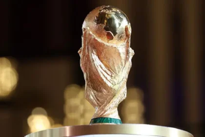 US Hotels Fear Weak World Cup Tourism as Bookings Fall Short Tourism expectations fail to match reality US hotels are worried the upcoming World Cup will not deliver the expected tourism boost. Many host cities are reporting lower-than-expected bookings, raising doubts about the event’s economic impact. A report from the American Hotel & Lodging Association shows demand is falling behind forecasts across most locations. The group represents more than 32,000 hotel properties and a large share of franchised hotels in the United States. Conflict between booking data and ticket sales The association says hotel demand does not match FIFA’s claim that over five million tickets have already been sold. It warns that the expected financial gains from the tournament could be lower than projected. Accusations over hotel room block bookings The report also criticizes FIFA for reserving large numbers of hotel rooms in advance. According to the association, this created artificial demand and pushed prices higher in early stages of booking. Later, FIFA cancelled a significant portion of those reservations. Hotel operators say this left gaps in availability and disrupted normal pricing patterns. FIFA has rejected these claims and does not agree with the criticism. Other factors behind weak demand Hotels say several issues are discouraging visitors. High ticket prices for matches are one concern. Expensive local transport and taxes are also adding pressure. Some operators also point to political tensions as another reason international travel interest has slowed. Economic outlook remains uncertain With lower bookings and mixed signals from ticket sales, the hospitality sector is now unsure about the World Cup’s overall economic benefit. Many hotels are preparing for weaker-than-expected revenue during the tournament period.