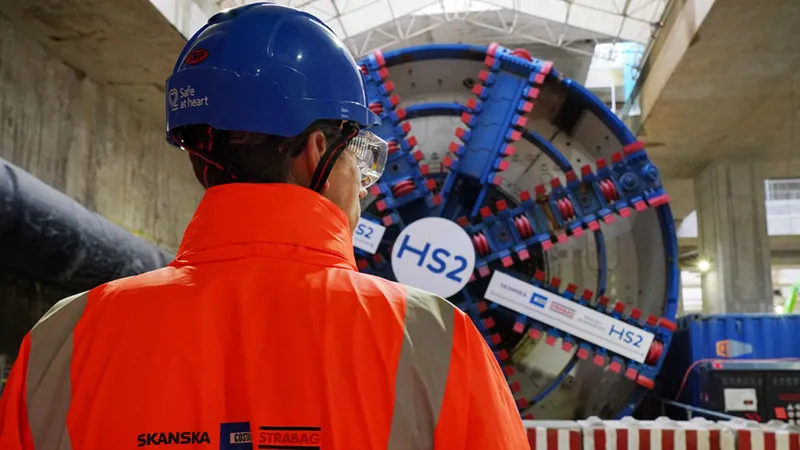 HS2 Project Faces Major Cost Rise and Delay The HS2 rail project in the United Kingdom is now expected to cost up to £102.7bn. The transport secretary confirmed the updated figures and said the government still plans to finish the project despite rising costs and delays. Officials described the situation as a full reset of the programme due to long running issues with spending, planning, and delivery. New Timeline Pushes Completion Further Back Train services on the HS2 line are now expected to begin between 2036 and 2039. This is up to six years later than the earlier target of 2033. The government said the delay is necessary because of ongoing construction challenges and rising costs. Work is still ongoing on key sections of the route between London and Birmingham. Train Speed Reduced to Cut Costs The original design planned for trains to run at 360 km per hour, or 224 miles per hour. That target has now been reduced to 320 km per hour. Officials said the lower speed will help reduce overall costs while still keeping the service significantly faster than existing rail lines. Spending Already Reaches £44.2bn By March 2026, £44.2bn had already been spent on HS2. The revised total cost now sits between £87.7bn and £102.7bn in 2025 prices. When adjusted to 2019 price levels, the total is roughly double the original budget range set under earlier plans. Political Criticism and Defence of the Project The transport secretary said the government inherited a project marked by serious failures in planning and management. She argued that HS2 had shifted from a symbol of progress to a sign of poor delivery. She also defended continuing the project, saying cancelling it would cost nearly as much as completing it, while delivering no transport benefits. She added that major infrastructure projects are still possible, but they require stronger management and better decision making. Project Scope Reduced from Original Plan HS2 was originally planned to extend from London to Manchester and Leeds. Those northern sections were later cancelled under previous governments. The current version of the project focuses on the route between London and Birmingham.