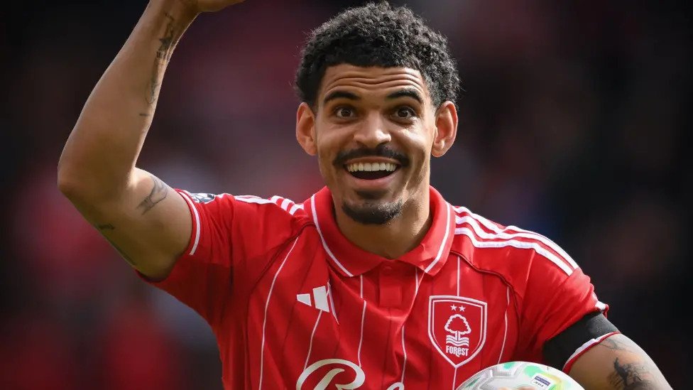 Morgan Gibbs White Emerges as Strong England Number 10 Option Gibbs White Impresses with Strong Premier League Form Morgan Gibbs White has played a key role in Nottingham Forest’s push toward Premier League safety. His form in the second half of the season has been especially strong and hard to ignore. He has scored thirteen goals in thirty five Premier League matches this season. Seven of those goals have come since the start of March. This sharp rise in output has pushed him into the spotlight at a crucial time. His performances show confidence, sharp movement, and better decision making in attacking areas. Forest have also benefited from his creativity and goal threat in key matches. England Number 10 Race Heats Up England manager Thomas Tuchel left Gibbs White out of a thirty five player squad for recent international friendlies against Japan and Uruguay. However, his recent form has changed the conversation around his national team future. The number ten position for England is now highly competitive. Gibbs White is now being discussed as a serious option for the role at the upcoming World Cup. He has added goals, assists, and energy in advanced midfield areas. This combination has made him difficult to ignore. Direct Comparison with Cole Palmer In Nottingham Forest’s three to one win over Chelsea, both Morgan Gibbs White and Cole Palmer featured in the same match for a short period. Palmer started for Chelsea but struggled to influence the game. He also missed a penalty and found it difficult to create chances. His season has been affected by injuries and limited impact, with only five goal contributions overall. Gibbs White came on in the second half and quickly made an impact. He provided an assist within minutes of entering the game. His direct involvement highlighted his current confidence and match sharpness. Competition for the Number 10 Role Despite his form, Gibbs White faces strong competition for the England number ten role. Other players in contention include Jude Bellingham from Real Madrid, Eberechi Eze from Arsenal, Morgan Rogers from Aston Villa, and Phil Foden from Manchester City. Each player brings different strengths, which makes the final decision more complex. England now have several creative midfield options, and consistency will likely decide who earns the starting role.