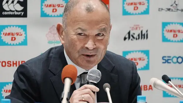 Eddie Jones Suspended as Japan Head Coach After Match Official Abuse Disciplinary Action Taken by JRFU Former England rugby head coach Eddie Jones has been fined and suspended from his role as Japan head coach after admitting to inappropriate comments directed at match officials during an under 23 tour in Australia last month. The Japanese Rugby Football Union confirmed the decision, saying the behaviour was serious enough to require strong disciplinary action under his contract. Jones has been removed from duty for six weeks and will miss Japan’s next four matches, including the opening Nations Championship fixture against Italy on 4 July. He will also be absent for two matches against a Hong Kong China Select team and a warm up game against the Maori All Blacks. The union has also reduced his salary as part of the punishment. Jones Issues Apology Jones accepted the sanction and expressed regret over his conduct. He said his remarks caused discomfort to local officials and others involved, and he apologised for the incident. The 66 year old acknowledged responsibility and said he understood the impact of his behaviour. Background and Recent Incidents Japan’s under 23 squad completed the tour with three wins from four matches, including a strong 38 to 21 victory over Randwick, a club closely linked to Jones’ coaching history. This is not the first time Jones has faced controversy since returning to Australia. After England’s series win over Australia in 2022, he was involved in tense exchanges with fans who accused him of disloyalty following his switch in coaching roles.