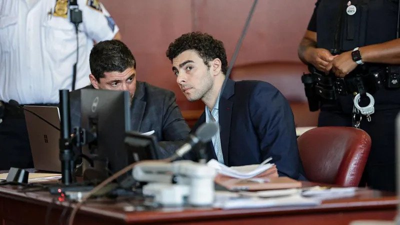 Judge Rules Key Evidence Admissible in Luigi Mangione Murder Trial Court Decision on Evidence A New York judge has decided that some evidence collected after Luigi Mangione’s arrest can be used in his murder trial related to the killing of UnitedHealthcare CEO Brian Thompson in 2024. Judge Gregory Carro allowed prosecutors to present a gun and written materials found later at a police station. At the same time, he blocked several items taken during an early search at a Pennsylvania McDonald's. Items Excluded From Trial The judge ruled that some evidence must be suppressed because officers carried out an improper search without a warrant. The excluded items include a magazine, mobile phone, passport, wallet, and a computer chip. These were taken from Mangione’s backpack at the McDonald's restaurant in Altoona, Pennsylvania. The court also removed some statements made during the initial police questioning at the restaurant. These included questions about his identity and whether he carried false identification. Evidence Allowed in Court Other evidence will still be shown during the trial. This includes items recovered later at a police station after Mangione was taken into custody. Police found a handgun inside the backpack during a detailed search at the station. Officers also recorded a notebook during inventory processing. The judge said this later search followed proper procedure and did not violate legal protections. Arrest and Investigation Background Police in Altoona responded in December 2024 after receiving a tip about a man matching images of the suspected shooter. Officers found Mangione inside a McDonald's and questioned him. He was later read his rights after initial contact. During the first search of his bag, officers discovered several personal items. A more detailed search at the police station uncovered additional materials. Mangione was arrested days after the shooting of Brian Thompson in New York City following a nationwide search. He faces charges including second degree murder, stalking, and firearm related offenses. He has pleaded not guilty in both state and federal cases. Defence Argument Mangione’s legal team argued that police violated constitutional rights during the arrest. They said officers searched his belongings without a warrant and improperly questioned him. The court agreed with part of this argument and removed some of the disputed evidence from the trial record.