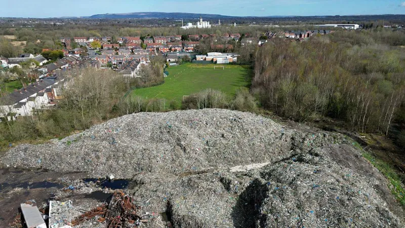 Major Waste Crime Sites Identified Authorities have published a new national watchlist highlighting illegal waste activity across England. The list includes 117 high priority sites linked to serious environmental concerns. Among them, 28 locations stand out as illegal waste super sites. Each of these contains more than 20,000 tonnes of dumped material. Officials estimate that around 700 illegal waste sites exist in total, but only the most urgent cases appear in the new list. The aim is to improve transparency and show where action is already underway. Largest Site Reaches 281,000 Tonnes The biggest site recorded is in Northwich, Cheshire. It holds about 281,000 tonnes of contaminated soil. This makes it the largest illegal waste site currently tracked. Investigations earlier this year had already identified similar large scale dumping issues in the same area. Other High Volume Locations Across England Several other major sites appear on the watchlist. These include locations in Wigan and Sheffield, which together hold close to 40,000 tonnes of waste. Additional large sites are spread across the country. Examples include Burnley, Retford, Scunthorpe, and St Austell, each holding between 50,000 and 99,000 tonnes. Other significant locations include areas in Suffolk, Essex, West Sussex, Cambridgeshire, and Worcestershire. One site in Pershore contains up to 199,000 tonnes of waste. Clean Up Work Already Underway Cleanup operations are already taking place at selected locations such as Hoads Wood in Kent and Kidlington in Oxfordshire. These sites were chosen because they pose serious environmental risks and affect nearby communities. Authorities confirm that cleanup decisions depend on strict risk based criteria set by the government. Funding Limits Slow Wider Action While some sites receive government funded cleanup support, many others remain without immediate action. Officials explain that limited funding restricts large scale removal work. As a result, only the most dangerous or high impact sites are prioritized. The Environment Agency continues to monitor all listed locations and respond where risks escalate.