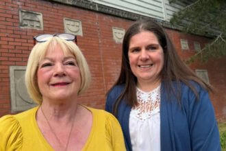 Two neighbours divided by Belfast peace wall turn barriers into friendship Physical wall turns short distance into long walk Lily Brannon, 73, and Michelle Bradley, 46, live in Belfast on opposite sides of a peace wall that separates the Springfield and Springmartin Road areas. Their homes are only about two minutes apart on foot. Because of the wall, the journey between them takes around 20 to 30 minutes. These peace lines exist across parts of Belfast to separate some Catholic nationalist and Protestant unionist communities. Friendship formed through cross community project The two women met through a cross community programme in west Belfast. The initiative runs at the Black Mountain Shared Space building and is supported by the International Fund for Ireland peace barriers programme. At first, both felt cautious. Michelle remembers a sense of reservation. Lily describes it as suspicion. That early tension faded as they spent more time together. From fear to trust Lily grew up before the Troubles, the decades of conflict that ended with the 1998 peace agreement. Michelle was born during the 1980s, when violence was still widespread. Michelle says she did not grow up with hate, but with fear of what she did not know. She believed people on the other side might already dislike her, even without meeting them. Strong bond despite history Over time, the two women built a close friendship. Lily now speaks warmly about Michelle and says she is someone she can rely on. Michelle has also formed a strong bond with Lily. Their relationship shows how everyday contact can reduce long held fears between communities that have been divided for decades. The International Fund for Ireland, which supports this kind of work, is marking 40 years of cross community efforts.
