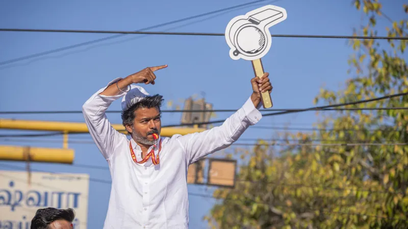 Political uncertainty in Tamil Nadu after actor Vijay’s party falls short of majority Historic win but no clear mandate C Joseph Vijay, a well known film star turned politician, has led his newly formed party Tamilaga Vettri Kazhagam (TVK) to a major breakthrough in Tamil Nadu’s state election. The party won 108 seats in the 234 member assembly, becoming the single largest party. However, it still fell 10 seats short of the 118 needed for a majority. This result created a hung assembly, leaving the state without a clear path to form a stable government. Coalition talks begin amid uncertainty After the results, the Indian National Congress, holding five seats, announced its support for TVK. Even so, Vijay still needs at least five more legislators to reach the majority mark. He met Tamil Nadu Governor Rajendra Vishwanath Arlekar and formally staked claim to form the government. The governor later stated that TVK has not yet shown proof of majority support in the assembly. Reports suggest the governor has asked Vijay to demonstrate backing from at least 118 members before any invitation to form government is considered. Debate over constitutional process TVK leaders and allies have criticized the governor’s approach, arguing that the single largest party should normally be given a chance to prove majority on the assembly floor. Legal and constitutional experts remain divided. Some say the governor is acting to ensure political stability, while others believe established convention supports inviting the largest party first and allowing a floor test later. A shift in Tamil Nadu politics TVK’s rise has been compared to earlier political disruptions in the state, especially when MG Ramachandran broke away to form AIADMK and later became chief minister. For decades, Tamil Nadu politics has been dominated by DMK and AIADMK. This election broke that pattern, with TVK emerging as the strongest single party and defeating the ruling DMK. Possible outcomes still open In the past few days, political discussions have intensified. There is even speculation about unlikely alliances between long time rivals. However, analysts say Vijay may still secure support from smaller parties and independents to reach the required number. The final outcome now depends on post election negotiations, not just the vote results.