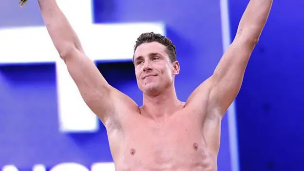 Record Swim at Controversial Event Kristian Gkolomeev from Greece delivered the fastest time ever recorded in the 50m freestyle, clocking 20.81 seconds in Las Vegas. His swim beat the official world best of 20.88 seconds set by Cameron McEvoy. Despite the result, sporting authorities will not recognise the time. The event does not follow international anti doping rules and allows performance enhancing drugs. Why the Result Is Not Official Global bodies such as the International Olympic Committee and the World Anti Doping Agency reject the competition. Athletes at the event are allowed to use substances banned in official sport. World Aquatics also criticised the competition, calling it a spectacle built on shortcuts. Officials argue that results from this setting cannot count as official records. Conditions and Rewards at the Event Gkolomeev competed using a polyurethane suit, which is not allowed in sanctioned races. Organisers rewarded him with 250 thousand dollars for winning and added a 1 million dollar bonus for the unofficial record. He said the result changed his life and would support his family. He also indicated he plans to return next year to attempt another record. Other Performances at the Enhanced Games Fred Kerley from the United States won the 100m sprint in 9.97 seconds. He did not match his personal best of 9.76 seconds. British swimmer Ben Proud won the 50m butterfly in 22.32 seconds. His time was close to the world record but did not surpass it. He expressed frustration at missing a record. Emily Barclay from Britain won the women 50m freestyle in 24.09 seconds. This was slower than the official world record. Strongman athlete Hafthor Bjornsson also competed but did not break his 510 kilogram deadlift record. Debate Around Drug Use in Sport The Enhanced Games allows substances approved for medical use in the United States, including testosterone and growth hormones. These are banned in traditional sport. Organisers say controlled enhancement is safer and more transparent than hidden doping. Critics argue it threatens fair competition and undermines sport integrity. Public Reaction and Attendance The event took place in front of about 2500 invited spectators. Tickets were not sold to the general public. Many sports authorities publicly criticised athletes who took part. Some organisations may impose bans on competitors in future events.