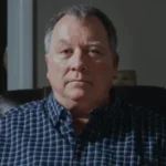Retired Officer Wins 835000 Dollar Settlement After Jail Time Over Facebook Post Case Overview A retired police officer from Tennessee has reached a settlement of 835000 dollars in a lawsuit over unlawful incarceration. He spent 37 days in jail after being arrested over a Facebook post related to the killing of Charlie Kirk. Authorities later dropped the felony charges against him. The case has drawn attention because of its connection to free speech and social media expression. What Led to the Arrest The man, Larry Bushart, shared a meme in a Facebook discussion about a vigil held for Charlie Kirk. The post appeared about 10 days after Kirk was killed at a speaking event in Utah. The meme included the line, “Seems relevant today,” along with a partial quote from a message by Donald Trump that referenced moving on after a school shooting tragedy. Police later arrested him at his home. Officials said the post was treated as a threat linked to mass violence at a school due to confusion over the school name mentioned in the context. Jail Time and Personal Impact Bushart was held in custody because he could not pay a 2 million dollar bond. He remained in jail for 37 days before charges were dismissed. During this time, he lost his post retirement job and missed the birth of his grandchild. His legal complaint focused on unlawful incarceration and violations tied to free speech protections. Settlement and Statement Bushart filed a lawsuit against Perry County, the local sheriff, and an investigator involved in the case. After reaching a settlement of 835000 dollars, he said his First Amendment rights were upheld. He also said public participation in civil discussion is important for a healthy democracy and that he plans to focus on family life moving forward.