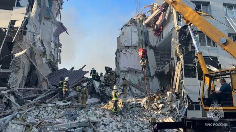 Russia Accuses Ukraine of Deadly Attack in Starobilsk Russian President Vladimir Putin has vowed to respond after accusing Ukraine of carrying out a deadly drone strike in the occupied town of Starobilsk in the Luhansk region. According to Russian officials, the overnight attack killed six people and injured 39 others. Authorities also said 15 people were still missing after the strike damaged a student dormitory building. Putin claimed the attack happened in three waves and involved 16 drones. Speaking at a reception in Moscow, he rejected suggestions that Russian air defence systems caused the destruction. He stated that no military or intelligence facilities were located near the building. Putin also instructed the Russian military to prepare plans for retaliation. Ukraine Says Russian Drone Unit Was Targeted Ukraine’s military later confirmed that its forces carried out a strike in Starobilsk. However, Ukrainian officials said the operation targeted the headquarters of Russia’s elite Rubicon drone military unit. Kyiv accused the Rubicon unit of launching repeated drone attacks against civilians and civilian infrastructure across Ukraine. Ukraine did not confirm whether the targeted building was the same dormitory mentioned by Russian authorities. The Ukrainian military stressed that its forces continue to follow international humanitarian law during military operations. Officials also said Ukrainian attacks focus only on military infrastructure and facilities connected to combat activities. Injured Student Shown on Russian Television Russian state television aired footage of an injured student identified as 19 year old Diana Shovkun. Reports said she suffered head injuries after a concrete slab collapsed during the strike. Russian media did not release images or videos of the people reportedly killed in the incident. The attack has increased tensions between Moscow and Kyiv as fighting continues across several occupied regions of Ukraine. Zelensky Claims Strike on Russian Security Headquarters Earlier this week, Ukrainian President Volodymyr Zelensky claimed Ukrainian forces also struck the headquarters of Russia’s Federal Security Service in the occupied Kherson region. Zelensky said around 100 Russian personnel were either killed or injured during that operation. Russia’s defence ministry has not officially commented on the claim. However, a pro Kremlin Telegram channel acknowledged casualties following what it described as a massive drone attack. War Continues as Both Sides Exchange Accusations Since the start of Russia’s full scale invasion in 2022, Ukraine has repeatedly accused Moscow of targeting civilians and damaging civilian infrastructure. Russia has consistently denied those accusations and claims its military operations focus only on strategic and military targets. The latest strike in Starobilsk adds to growing tensions as both countries continue drone and missile attacks during the ongoing war.
