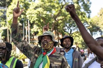 South Africa Denies Viral Videos Showing Xenophobic Attacks South Africa has strongly rejected viral videos and images that allegedly show attacks on foreign nationals. Government officials say the clips are fake and designed to damage the country’s international image. The issue has increased diplomatic tension between South Africa and several African nations. Governments across the continent have expressed concern over reports of growing anti immigrant sentiment and possible threats against foreign citizens living in the country. African Countries Raise Concerns Ghana officially contacted the African Union and asked for discussions on the situation. Ghana described the reports as a serious threat to the safety and wellbeing of Africans living in South Africa. The country also requested a fact finding mission to investigate the claims. Nigeria also raised concerns and offered to help repatriate its citizens who may feel unsafe. Meanwhile, Kenya, Malawi, Lesotho, and Zimbabwe advised their nationals in South Africa to stay alert. South African authorities responded by saying the country has nothing to hide and remains committed to African unity. Government Calls Videos Misleading Minister in the Presidency Khumbudzo Ntshavheni said the circulating footage and images were fake and misleading. According to the government, the content aims to damage South Africa’s reputation and weaken its efforts to promote stronger relations across Africa. The controversy began after several videos spread online over the past two weeks. Some clips appeared to show groups confronting people suspected of being undocumented immigrants. In one widely shared video, a man believed to be from Ghana was reportedly told to return and “fix his country.” Despite the viral content, officials insist many of the claims surrounding the footage are inaccurate or exaggerated. Immigration Protests Continue Thousands of South Africans have recently joined protests in major cities demanding stricter action against illegal immigration. Demonstrators argue that undocumented migration affects jobs, housing availability, and crime levels. The government acknowledged that citizens have the legal right to protest. However, officials warned against violence and unlawful actions during demonstrations. Unlike previous periods of xenophobic unrest in South Africa, authorities say the latest protests have mostly remained peaceful. There have been no confirmed reports of widespread looting or attacks targeting foreign owned businesses. Ramaphosa Says South Africa Welcomes Foreign Nationals Presidential spokespersons for Cyril Ramaphosa stated that South Africa remains a welcoming nation. The presidency also rejected claims that South Africans are generally xenophobic. Xenophobia has remained a sensitive issue in South Africa for years. Past outbreaks of violence against migrants have caused concern across Africa. The latest controversy has once again placed the issue under international attention.