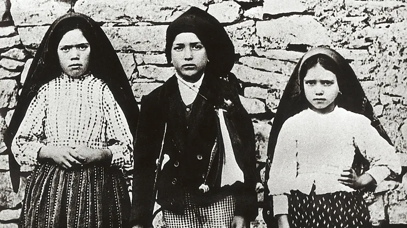 The Fátima Prophecies and the “Miracle of the Sun” That Shaped Cold War Beliefs Three Children Claimed They Saw a Divine Vision in Portugal In May 1917, three young shepherd children from Fátima, Portugal, claimed they witnessed an apparition of the Virgin Mary while tending sheep in a field. The children, Lucia dos Santos and her cousins Francisco and Jacinta Marta, said the glowing figure appeared near an oak tree and instructed them to return on the 13th day of each month for the next five months. Their story quickly spread across Portugal and attracted thousands of believers. Over time, the reported visions became one of the most discussed religious events of the 20th century. Many people believed the messages contained warnings about war, faith, and the future of Russia under communism. The “Miracle of the Sun” Drew Thousands of Witnesses On 13 October 1917, a massive crowd gathered in Fátima to witness the final predicted appearance. Many people later claimed they saw extraordinary events in the sky. Witnesses described the Sun changing colors, spinning rapidly, and moving like a wheel of fire. Some also reported seeing flower-like shapes falling from the sky. Others believed people with illnesses were suddenly healed during the event. One witness recalled that the Sun appeared to spin faster and faster before returning to its normal position. While many people considered it a miracle, others suggested it may have been a natural atmospheric event or a case of mass psychological influence. Despite the debate, the event left a strong emotional impact on those who attended. Fear, faith, and wonder spread through the crowd as people tried to understand what they had seen. The Three Secrets of Fátima The children claimed they received three important revelations during the apparitions. These became known as the “Three Secrets of Fátima.” The first secret reportedly included a vision of Hell and warnings about future suffering and war. Many believers later connected it to the outbreak of World War II. The second prophecy focused on Russia. According to the message, devotion and prayer could eventually save Russia from communism. Because the message emerged shortly before the Russian Revolution, it later gained major attention during the Cold War. The third secret remained hidden inside the Vatican archives for decades. Its secrecy created worldwide speculation and increased global interest in Fátima. Many people believed it predicted major political and religious events of the 20th century. How Fátima Became Linked to Anti Communist Beliefs As communism spread across Eastern Europe and the Soviet Union grew stronger, the Fátima prophecies became closely tied to anti communist movements. Religious groups viewed the messages as spiritual warnings against atheism and Soviet ideology. Although the Catholic Church initially reacted cautiously to the reports, it officially approved devotion connected to Fátima in 1930. From that point forward, the site became one of the world’s most visited religious pilgrimage destinations. Today, the story of Fátima continues to spark debate between believers, historians, and scientists. Some see it as a powerful spiritual event, while others view it as a historical mystery shaped by faith and human emotion.
