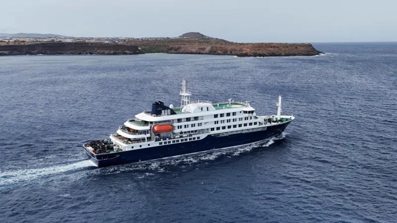Third British National Suspected of Hantavirus on MV Hondius Cruise as Cases Rise Outbreak Overview on MV Hondius Health officials are monitoring a hantavirus outbreak linked to the cruise ship MV Hondius. A third British national is now suspected to have the infection. The case involves a passenger currently on the remote Atlantic island of Tristan da Cunha after the ship made a stop there in mid April. Two other British men already have confirmed infections. One patient remains in a stable condition in the Netherlands after evacuation from the ship. The second patient is in intensive care in South Africa following an earlier medical transfer. One passenger has died, and the total number of confirmed cases has reached five. Confirmed and Suspected Cases Authorities confirmed that the suspected third British case is under observation and has not yet been fully diagnosed. Two additional British nationals are self isolating at home in the United Kingdom. They show no symptoms and are isolating voluntarily after possible exposure. A group of 30 passengers from around a dozen countries disembarked earlier at St Helena on 24 April. Seven of them were British citizens. Four British passengers who left the ship remain on St Helena and continue to show no symptoms while staying in contact with health teams. Evacuation and Medical Response Medical teams evacuated three patients from the ship earlier in the week. Martin Anstee, a 56 year old retired police officer and expedition guide, was flown to the Netherlands along with a 41 year old Dutch crew member and a 65 year old German passenger. He is currently in stable condition and reports that he feels well. Health authorities plan to send medical support to remote island locations where exposed passengers are being monitored. Teams are focusing on early detection and containment to prevent further spread. Passenger Monitoring and Isolation Measures Passengers who remain on board the MV Hondius will be flown back to the United Kingdom via a chartered aircraft once the ship reaches the Canary Islands. Officials confirmed that all returning passengers will need to isolate after arrival, even if they show no symptoms. Health monitoring continues for all exposed individuals across multiple locations, including Europe, Africa, and remote Atlantic islands. Operator Response and Contact Tracing The cruise operator Oceanwide Expeditions stated that the first confirmed infection was reported on 4 May. The company also confirmed that all passengers who had disembarked were contacted and informed about potential exposure risks.
