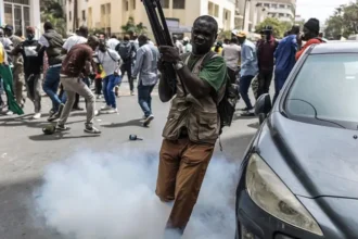 Senegal Lawmakers Approve Constitutional Reforms Amid Growing Political Tensions Senegal's parliament has approved a controversial package of constitutional reforms that would increase the powers of lawmakers while limiting some presidential authority. The decision has sparked political tensions and street protests, as critics claim the changes are driven by political rivalry rather than democratic reform. The reforms were passed with a large majority after a heated debate in parliament. Demonstrators gathered outside the National Assembly to protest the proposed constitutional changes, while opposition lawmakers staged a walkout during the session. Political Alliance Turns Into Power Struggle President Bassirou Diomaye Faye and parliamentary Speaker Ousmane Sonko came to power together in 2024 after promising major political and economic reforms. However, their relationship has steadily deteriorated over the past several months. The disagreement intensified after Sonko publicly criticized President Faye's handling of Senegal's economic and debt challenges. In May, President Faye removed Sonko from the position of prime minister. Soon afterward, lawmakers from the ruling Pastef party elected Sonko as Speaker of the National Assembly, giving him significant influence over parliament. Key Constitutional Changes The proposed constitutional reforms would strengthen the role of parliament and increase oversight of government decisions. The main proposals include: Expanding the investigative powers of parliamentary committees. Requiring the government to present agreements involving natural resources to parliament. Replacing the current Constitutional Council with a new Constitutional Court consisting of nine members instead of seven. Preventing a sitting president from leading a political party while serving in office. Restricting a president from signing certain laws between a presidential election and the inauguration of the newly elected president. Supporters argue these measures will improve the balance of power among the executive, legislative, and judicial branches of government. Opposition Raises Concerns Opposition parties and civil society organizations strongly oppose the reforms. They argue that the changes are politically motivated and designed to weaken President Faye while increasing the influence of Speaker Sonko and the parliamentary majority. Outside parliament, police used tear gas to disperse protesters who had gathered to oppose the constitutional amendments. The demonstrations reflected growing public concern over Senegal's political future. Referendum Planned Justice Minister Moussa Sarr announced that President Faye intends to submit the constitutional reforms to a national referendum. However, no official voting date has been announced. Speaker Sonko questioned whether the president has the authority to organize a referendum after parliament had already approved the amendments with a majority vote. The debate has created fresh uncertainty in Senegal's political landscape, with both supporters and critics waiting to see whether the proposed reforms will receive public approval in a nationwide vote. What Happens Next? The constitutional reforms are expected to remain at the center of Senegal's political debate in the coming months. If the referendum moves forward, voters will decide whether the proposed changes become part of the country's constitution. The outcome could significantly reshape the balance of power between the presidency and parliament.