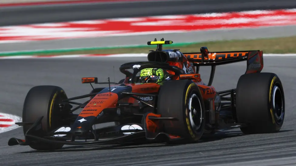 # Norris Encouraged as McLaren Returns to the Front in Barcelona Lando Norris believes McLaren is moving in the right direction after the team delivered a strong performance during Friday practice at the Barcelona Catalunya Grand Prix. The British driver set the fastest lap of the day, finishing just 0.009 seconds ahead of Mercedes driver George Russell. McLaren teammate Oscar Piastri also impressed by taking third place, only 0.057 seconds behind Norris. ## McLaren Finds Speed Again in Barcelona McLaren arrived in Spain looking for answers after disappointing weekends in Monaco and Canada. The team struggled for pace at both events, and Norris failed to finish either race. However, the opening practice sessions in Barcelona painted a much more positive picture. Norris said the circuit suited the car better and allowed the team to operate in a stronger performance window. He explained that Barcelona's layout is very different from Monaco and Canada. The improved balance gave the team more confidence and helped unlock better speed throughout the day. Although Norris was pleased with the result, he admitted there is still work to do before qualifying and the race. ## Mercedes Staying Close to McLaren Mercedes also looked competitive. Russell finished second and remained within touching distance of Norris. Rookie championship leader Kimi Antonelli ended the session in fifth place. He missed the first practice session after Mercedes handed reserve driver Frederik Vesti valuable track time. Antonelli said tyre management remained a challenge because the hot conditions caused overheating. Despite that, he felt positive about the team's long run pace and expected further improvements on Saturday. Mercedes deputy team principal Bradley Lord praised both drivers and noted that the battle at the front appears extremely close. He also highlighted Ferrari's strong race pace during longer runs. ## Ferrari Showing Strong Long Run Pace Charles Leclerc finished fourth fastest and continued to show encouraging pace for Ferrari. Data from the longer race simulations suggested Ferrari could be a serious threat during Sunday's race. Leclerc's performance on medium tyres compared favorably with Mercedes and McLaren. Lewis Hamilton, however, experienced a more difficult session. After missing the opening practice due to Ferrari's junior driver program, he finished ninth on the timesheets and struggled to find consistent speed. ## Verstappen Faces Difficult Start Red Bull endured a frustrating Friday as Max Verstappen finished sixth, almost nine tenths of a second behind Norris. The Dutch driver reported grip problems in every type of corner. He said the car lacked balance and failed to provide the confidence needed to attack the circuit. Verstappen admitted Red Bull is currently not in a position to challenge McLaren and Mercedes at the front. He also noted that changing track conditions and strong winds made the situation even more difficult. ## Tight Battle Expected This Weekend Friday's practice sessions suggest McLaren has taken an important step forward after recent setbacks. Norris and Piastri both looked competitive, while Mercedes and Ferrari remain close contenders. Although race pace data produced mixed results, McLaren appears far stronger than it did in Monaco and Canada. With qualifying still to come, fans can expect a closely fought battle between several teams at the front of the grid.