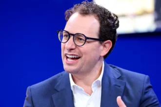 Anthropic Moves Toward US IPO as AI Market Approaches Record Valuations Anthropic Prepares for Public Listing in the US Artificial intelligence company Anthropic has started the process of going public in the United States. The firm, known for its chatbot Claude, has filed paperwork with US regulators to begin an initial public offering. The company has not confirmed the share price or how many shares will be offered yet. Anthropic was founded just five years ago and has quickly grown into one of the leading AI companies in the world. Recent private funding placed its valuation above $965 billion, putting it close to the trillion-dollar mark. AI Valuations Push Toward Historic Levels The planned IPO comes at a time when investor interest in artificial intelligence is extremely high. Anthropic is now competing directly with other major players such as OpenAI and SpaceX in attracting large scale investment. OpenAI is also considering a public listing. Its most recent valuation stands at around $852 billion, slightly below Anthropic’s latest private estimate. SpaceX is also preparing for a possible stock market debut that could reshape investor expectations for technology companies. Alphabet, the parent company of Google, has also announced plans to raise about $80 billion to expand its AI investments. This shows how strongly major tech firms are competing in the AI space. Competition Between Anthropic and OpenAI Intensifies Anthropic was founded by Dario Amodei after he left OpenAI due to strategic disagreements with its leadership. Since then, both companies have developed advanced AI systems and now compete for users, enterprise customers, and investor funding. OpenAI chief executive Sam Altman has stated that his company will go public when the timing is right, but there is no urgency. Both firms are now seen as key players in the race to dominate generative AI. Investor Debate on Timing and Market Risk Market analysts are closely watching how and when these companies choose to list. Some experts believe Anthropic could help set new standards for valuing AI businesses, especially around revenue, subscribers, and enterprise adoption. Others argue that being first to market may be an advantage, as it allows a company to shape investor expectations. If a company delays too long, it may lose that influence. Investors are also interested in Anthropic’s financial performance, especially profitability, which will be closely studied once official IPO documents are released. AI Industry Enters Capital Intensive Phase Experts say the AI sector is entering a phase that requires massive investment. Companies are spending heavily on infrastructure, research, and model development. This capital demand is driving the push toward public markets. If Anthropic, OpenAI, and SpaceX all go public, it could create one of the largest technology investment waves in stock market history.