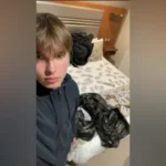 Alleged Hitman Teen Mocked Police During Huddersfield Arrest Arrest at Briar Court Hotel A 19 year old Norwegian man named Johannes Natland has been accused of travelling to the United Kingdom for a planned killing linked to organised crime. Police arrested him at the Briar Court Hotel in Huddersfield. Officers found two firearms and 12 live rounds of ammunition. Body worn camera footage shown at the Old Bailey captured the moment he opened his hotel room door. A laser sight was pointed at his chest. He then allegedly mimed holding a gun and acted out shooting toward officers. Charges and Court Plea He has admitted possession of two working firearms and ammunition. He denies conspiracy to murder. Prosecutors claim he was sent to the UK to carry out a targeted killing for a criminal group known as Foxtrot Network. They say the group has links to Iran. The case is being heard at the Old Bailey. Messages and Travel Into the UK Court evidence says he joined a Signal group chat shortly after turning 18. He reportedly asked who the target was soon after joining. He later travelled from Stavanger in Norway to Manchester using an emergency passport. At the airport, Border Force officers questioned him. He had only a small amount of cash, no return ticket, and no accommodation booked. He was refused entry but allowed a temporary stay before a planned return flight. Cash Drops and Firearms Instructions After arriving in the UK, he took a taxi to Huddersfield. He was allegedly guided by messages to hidden cash near a walkway underpass. He collected the money and checked into a hotel, paying in cash. Further instructions reportedly led him to woodland outside the town, where he collected two handguns. He was also directed to a stolen car with a hidden key placed under a wheel. Online Sharing and Behaviour Later that day, he bought alcohol and sent videos of the weapons to a friend. He also sent images showing cash spread across a hotel bed. In another image shared earlier, he posed with money laid out in front of him inside the hotel room.