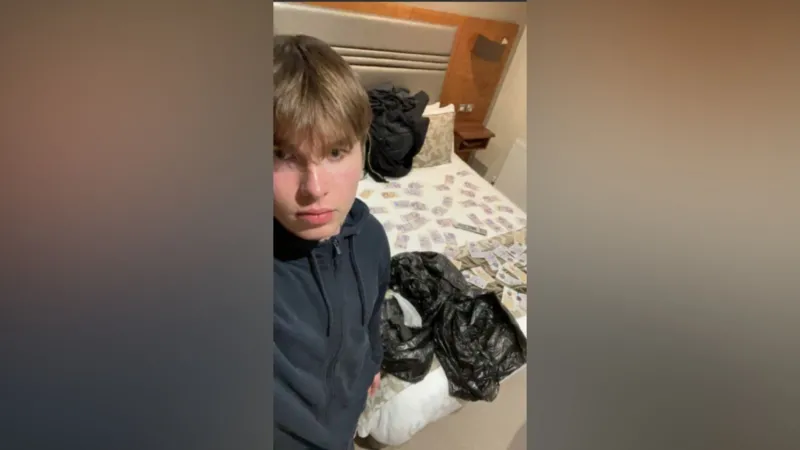 Alleged Hitman Teen Mocked Police During Huddersfield Arrest Arrest at Briar Court Hotel A 19 year old Norwegian man named Johannes Natland has been accused of travelling to the United Kingdom for a planned killing linked to organised crime. Police arrested him at the Briar Court Hotel in Huddersfield. Officers found two firearms and 12 live rounds of ammunition. Body worn camera footage shown at the Old Bailey captured the moment he opened his hotel room door. A laser sight was pointed at his chest. He then allegedly mimed holding a gun and acted out shooting toward officers. Charges and Court Plea He has admitted possession of two working firearms and ammunition. He denies conspiracy to murder. Prosecutors claim he was sent to the UK to carry out a targeted killing for a criminal group known as Foxtrot Network. They say the group has links to Iran. The case is being heard at the Old Bailey. Messages and Travel Into the UK Court evidence says he joined a Signal group chat shortly after turning 18. He reportedly asked who the target was soon after joining. He later travelled from Stavanger in Norway to Manchester using an emergency passport. At the airport, Border Force officers questioned him. He had only a small amount of cash, no return ticket, and no accommodation booked. He was refused entry but allowed a temporary stay before a planned return flight. Cash Drops and Firearms Instructions After arriving in the UK, he took a taxi to Huddersfield. He was allegedly guided by messages to hidden cash near a walkway underpass. He collected the money and checked into a hotel, paying in cash. Further instructions reportedly led him to woodland outside the town, where he collected two handguns. He was also directed to a stolen car with a hidden key placed under a wheel. Online Sharing and Behaviour Later that day, he bought alcohol and sent videos of the weapons to a friend. He also sent images showing cash spread across a hotel bed. In another image shared earlier, he posed with money laid out in front of him inside the hotel room.