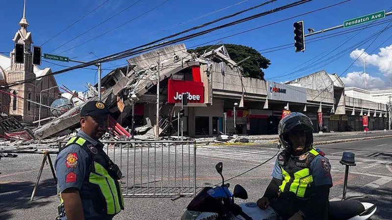 # Major Earthquake in Southern Philippines Kills 32, Triggers Tsunami Alerts A powerful 7.8 magnitude earthquake struck off the coast of Mindanao in the southern Philippines on Monday morning, leaving at least 32 people dead and more than 100 injured. The strong tremor caused widespread destruction, triggered tsunami warnings across several countries, and forced thousands of residents to evacuate. Authorities continue to assess the full impact of the disaster as rescue teams search for missing people and clear damaged areas. ## Tsunami Warnings Issued Across the Region The earthquake occurred at 7:37 AM local time near Mindanao, the Philippines' second largest island. Shortly after the quake, officials issued tsunami alerts for the Philippines, Indonesia, Japan, and Australia. Emergency agencies closely monitored coastal areas. Although authorities later cancelled some warnings, many residents moved to safer locations as a precaution. ## Death Toll Rises as Rescue Efforts Continue Local officials reported that at least 32 people lost their lives due to the earthquake and its aftermath. Many deaths occurred when landslides struck communities in the province of Sarangani, located close to the quake's epicentre. Rescue workers continue searching for nearly two dozen missing individuals. More than 100 people suffered injuries, while emergency teams remain on high alert. ## Sarangani and General Santos Among Worst-Hit Areas Sarangani province recorded the highest number of fatalities, with 17 confirmed deaths. Landslides caused much of the destruction in the area. The earthquake also temporarily disrupted power and communication services, though crews restored most connections later in the day. General Santos City, the closest major city to the epicentre, reported 10 deaths. Authorities also confirmed that several residents remain unaccounted for. The city is widely known for its fishing industry and as the hometown of former world boxing champion and politician Manny Pacquiao. ## Buildings Collapse and Infrastructure Suffers Damage The powerful quake damaged homes, roads, and commercial buildings across several provinces. Videos shared online showed significant structural damage, including the collapse of a Jollibee fast-food restaurant. Authorities also reported damage in South Cotabato and Sultan Kudarat. Engineers are inspecting buildings to determine whether they remain safe for public use. ## Thousands Evacuated for Safety Officials evacuated approximately 10,000 residents from vulnerable areas after the earthquake. Emergency shelters opened to accommodate affected families. Schools in several regions suspended classes following the disaster. The earthquake struck on the first day of the new school year, disrupting activities for thousands of students. In Davao Occidental, footage from a local school showed students gathering in open spaces while the ground shook. Despite the frightening scenes, school officials confirmed that no students suffered injuries. ## Government Mobilizes Disaster Response Philippine President Ferdinand Marcos Jr directed government agencies to coordinate relief and rescue operations. Authorities continue delivering assistance to affected communities and monitoring conditions in high-risk areas. Emergency teams are expected to provide updated casualty figures and damage assessments as rescue operations progress. ## Ongoing Assessment Mindanao is home to approximately 26 million people, making it one of the country's most populated regions. Officials warn that casualty numbers may change as verification efforts continue. Authorities are urging residents to remain cautious, follow safety instructions, and stay informed through official channels while recovery efforts move forward.