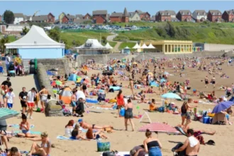 Teen suffers life changing injury after Barry Island attack A 17 year old boy from Cardiff has had his leg amputated after being stabbed during an incident at Barry Island on 25 May. Police confirmed the injury turned out to be far more serious than doctors first believed. Emergency treatment and critical condition The teenager was rushed to the University Hospital of Wales in Cardiff, where he received urgent care. Medical staff initially did not expect the injury to be life threatening or permanently disabling. His condition later worsened, leading to the decision to amputate his leg. Police investigation continues South Wales Police said the teenager remains in critical care support during recovery. Officers are reviewing hundreds of hours of CCTV footage from the area and are also working to identify and speak with witnesses who may have seen what happened. Suspect released on bail An 18 year old man from Cardiff was arrested on suspicion of causing serious harm with intent. He has been released on bail while police continue their enquiries. Family receiving support Investigating officers described the situation as deeply distressing for the victim and his family. A specially trained family liaison officer has been assigned to support them during this difficult time.
