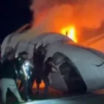 Bystanders Help Rescue Passengers After Fiery Private Jet Crash in Texas Quick action at the crash site A private jet traveling from Los Cabos, Mexico to Austin, Texas crashed onto a motorway near Laredo after reporting serious mechanical trouble. The plane went down close to Laredo airport and burst into flames on impact. Nearly a dozen bystanders and emergency responders rushed in to help. Using tools like a shovel and a sledgehammer, they forced open a door and pulled trapped passengers out before the fire spread further. Casualties and survivors Authorities confirmed that six people were onboard. One person died in the crash, while five others survived and were taken to hospital. Officials said the survivors are in stable condition. The identity of the person who died has not been released. Vehicle struck during impact Investigators said the aircraft also hit a vehicle during the crash on Loop 20 motorway. It is still unclear which part of the plane struck the vehicle. Emergency response and injuries Thick smoke and fire covered the wreckage, according to videos shared online. Five first responders were treated for smoke inhalation after helping at the scene. Road closure and investigation Loop 20 remains closed as investigators continue their work. The probe involves local police, the Federal Bureau of Investigation, and the National Transportation Safety Board. Officials expect the road to stay shut while they examine the cause of the crash and the mechanical issues reported before impact.