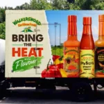 Caribbean Hot Sauce Industry Hit by Scotch Bonnet Pepper Shortage Key Ingredient Under Pressure Hot sauce is a daily essential across Caribbean households. Scotch bonnet peppers give it the signature heat found in meals like rice and peas, curries, and stews. Demand for Caribbean hot sauce has also grown internationally. These products now appear in major supermarkets in the United States, United Kingdom, and Australia. However, producers are now struggling to keep up with supply because the main ingredient is becoming harder to source. Weather Damage Disrupts Farming Farmers in Jamaica, a major Scotch bonnet producing country, have faced repeated setbacks from extreme weather. Recent hurricanes caused serious damage to farmland and crops. Heavy rainfall also affected plant growth and reduced pepper quality. In some cases, excess rain reduced the heat level of the peppers, which directly impacts sauce flavour. Farmers also deal with plant diseases and pests that weaken harvests and reduce yields. Because of these combined pressures, production has dropped and supply has tightened. Farmers Switch Crops for Stability Many farmers have reduced Scotch bonnet cultivation after repeated losses. Some have shifted to crops like sweet potatoes because they are more stable and offer better financial security. This shift has reduced the overall supply of Scotch bonnet peppers even further, making it harder for sauce manufacturers to maintain production levels. Rising Prices and Supply Challenges Hot sauce manufacturers report major cost increases due to limited pepper availability. Some producers say pepper prices rose sharply after major storms, with increases reaching around 10 times in the short term. Over the last two years, costs have climbed by roughly 40 to 50 percent. Companies that rely heavily on exports have also been forced to cancel orders when supply runs low. To manage shortages, some businesses are increasing storage of peppers throughout the year. This helps reduce sudden supply gaps but adds extra cost and risk. Cultural Importance and Industry Impact Scotch bonnet peppers hold strong cultural value in Jamaica and across the Caribbean. They are used in nearly every type of local cooking and are a core part of national identity. Hot sauce producers say demand remains strong both locally and abroad, but supply instability is now their biggest challenge. As climate conditions continue to change, the industry faces ongoing uncertainty about future harvests and pricing stability.