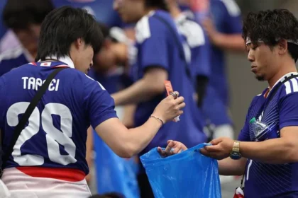 # Japanese World Cup Fans Praised for Stadium Cleanup but Face Criticism at Home ## Japanese Fans Applauded for Stadium Cleanup Japanese football fans have once again gained international attention for cleaning stadiums after World Cup matches. Photos showing supporters collecting trash from the stands quickly spread online and received praise from football fans around the world. Cleaning up public spaces is a long standing tradition in Japan. Many people view it as a sign of respect and responsibility. As a result, Japanese supporters are often recognized for leaving stadiums clean after major sporting events. ## Viral Debate Highlights Household Responsibilities While many people admired the gesture, others in Japan raised a different question. They asked whether the same level of responsibility exists inside the home. A viral social media post sparked the discussion. The image showed a man cleaning a stadium after a football match. Next to it was another image of the same man relaxing on a sofa while his wife handled household chores. The message encouraged Japanese men to contribute more to housework. It suggested that public acts of cleanliness should be matched by equal effort at home. The post quickly gained attention and received more than 60,000 likes on X. Many users joined the conversation. Some argued that helping with daily household tasks is just as important as cleaning public spaces. Others pointed out that many women continue to carry most of the responsibility for childcare and housework. ## Japanese Men Spend Less Time on Housework Recent data supports these concerns. According to figures from the Organisation for Economic Co operation and Development (OECD), Japanese men spend far less time on unpaid household work than women. Data from 2021 shows that women spend more than three hours each day on unpaid work. Men spend only 47 minutes on average. The gap becomes even wider in families with young children. A government survey found that women in dual income households with children under six spend more than seven hours a day on childcare and household duties. Men spend less than two hours. ## Calls for Greater Equality at Home The discussion has renewed calls for a more balanced division of household responsibilities. Many people believe men should play a larger role in childcare, cooking, cleaning, and other daily tasks. Supporters of this view say public behavior should reflect private behavior. They argue that true responsibility includes helping both in the community and at home. As Japanese fans continue to receive praise for their stadium cleanup efforts, the debate has also highlighted a broader issue. Many people now hope the same spirit of teamwork and responsibility can extend beyond the football stadium and into everyday family life.