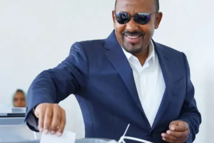 Ethiopia Election Results: Abiy Ahmed Secures Landslide Victory Amid Rising Security Concerns Election outcome and political dominance Ethiopian Prime Minister Abiy Ahmed’s Prosperity Party has secured a sweeping victory in the general election, winning 438 of the 501 contested seats. This result ensures another term for Abiy and confirms his strong control over parliament. The government is expected to continue under his leadership when he is sworn in for a new term in October. Supporters of Abiy say the outcome reflects stability and progress. They point to economic reforms and development efforts as signs of positive change in the country. Low participation and disputed legitimacy The election took place in a tense environment. Several opposition groups did not take part, and many questioned the fairness of the process. Security problems also disrupted voting in parts of the country. On election day, 143 polling stations did not open in the two most populated regions due to clashes involving armed groups. This raised further doubts about how inclusive the vote could be. Armed conflict and regional instability Security remains one of Ethiopia’s biggest challenges. Armed groups such as the Fano militia in Amhara and the Oromo Liberation Army in Oromia rejected the election results. Both groups are pushing for greater autonomy and continue to clash with government forces. In Tigray, the situation is still fragile after a two year civil war that ended in 2022. The region, which includes around six million people, was fully excluded from the election. This exclusion increased fears that tensions could escalate again. Tensions with Eritrea and regional risks Relations between Ethiopia and Eritrea have also worsened. During the Tigray conflict, the two countries were aligned against Tigrayan forces. Since then, relations have broken down sharply. Ethiopia has repeatedly raised the issue of access to a Red Sea port, which it lost after Eritrea became independent in 1993. Eritrea, in turn, accuses Ethiopia of expansionist ambitions. Analysts warn that shifting alliances between Eritrea, Tigrayan leaders, and Ethiopian authorities could increase the risk of renewed regional conflict. Wider regional instability Ethiopia is also facing external pressure linked to the ongoing war in Sudan. Reports have suggested possible Ethiopian support for one of Sudan’s armed factions, although the government denies this. The situation adds another layer of uncertainty in an already volatile region.