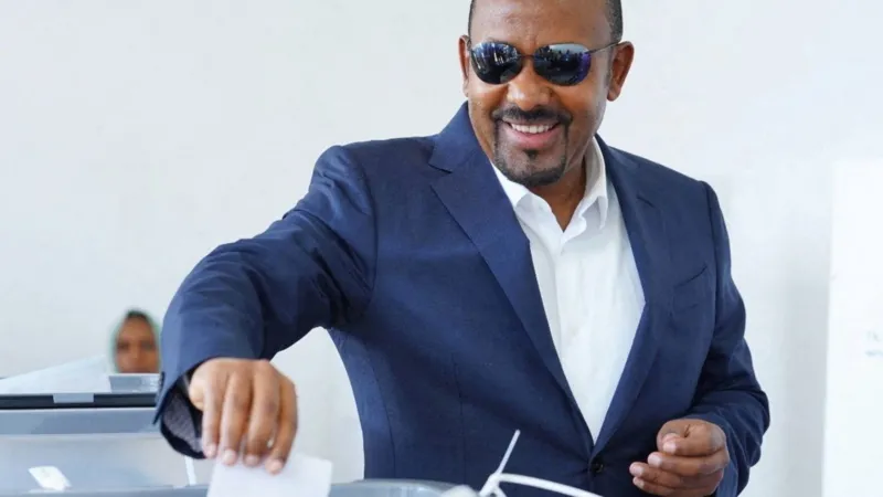 Ethiopia Election Results: Abiy Ahmed Secures Landslide Victory Amid Rising Security Concerns Election outcome and political dominance Ethiopian Prime Minister Abiy Ahmed’s Prosperity Party has secured a sweeping victory in the general election, winning 438 of the 501 contested seats. This result ensures another term for Abiy and confirms his strong control over parliament. The government is expected to continue under his leadership when he is sworn in for a new term in October. Supporters of Abiy say the outcome reflects stability and progress. They point to economic reforms and development efforts as signs of positive change in the country. Low participation and disputed legitimacy The election took place in a tense environment. Several opposition groups did not take part, and many questioned the fairness of the process. Security problems also disrupted voting in parts of the country. On election day, 143 polling stations did not open in the two most populated regions due to clashes involving armed groups. This raised further doubts about how inclusive the vote could be. Armed conflict and regional instability Security remains one of Ethiopia’s biggest challenges. Armed groups such as the Fano militia in Amhara and the Oromo Liberation Army in Oromia rejected the election results. Both groups are pushing for greater autonomy and continue to clash with government forces. In Tigray, the situation is still fragile after a two year civil war that ended in 2022. The region, which includes around six million people, was fully excluded from the election. This exclusion increased fears that tensions could escalate again. Tensions with Eritrea and regional risks Relations between Ethiopia and Eritrea have also worsened. During the Tigray conflict, the two countries were aligned against Tigrayan forces. Since then, relations have broken down sharply. Ethiopia has repeatedly raised the issue of access to a Red Sea port, which it lost after Eritrea became independent in 1993. Eritrea, in turn, accuses Ethiopia of expansionist ambitions. Analysts warn that shifting alliances between Eritrea, Tigrayan leaders, and Ethiopian authorities could increase the risk of renewed regional conflict. Wider regional instability Ethiopia is also facing external pressure linked to the ongoing war in Sudan. Reports have suggested possible Ethiopian support for one of Sudan’s armed factions, although the government denies this. The situation adds another layer of uncertainty in an already volatile region.