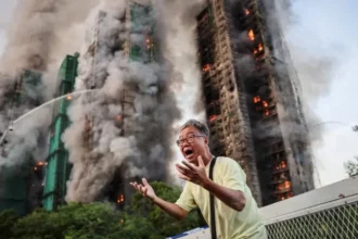 # Hong Kong Files First Criminal Charges in Deadly Wang Fuk Court Fire Case ## Major Legal Action After Deadly Housing Complex Fire Hong Kong authorities have filed the first criminal charges related to the devastating fire at Wang Fuk Court, a tragedy that claimed 168 lives and left thousands without homes. The incident, which occurred in November last year, became the city's deadliest fire disaster in more than seven decades. Prosecutors charged two companies and seven individuals with a total of 25 offences. The allegations include manslaughter, fraud, corruption, money laundering, tax evasion, and attempting to obstruct justice. ## Companies and Executives Face Manslaughter Charges Authorities charged engineering consultancy firm Will Power Architects and construction contractor Prestige Construction and Engineering with manslaughter. Several senior figures also face criminal charges. These include Prestige director Ho Kin-yip, Will Power director Wong Hap-yin, and registered inspector Ng Yeuk. Officials denied bail to all three men during a court hearing on Wednesday. Investigators believe serious safety failures contributed directly to the scale of the disaster. ## Investigation Reveals Critical Safety Failures An independent inquiry found multiple breaches of fire safety regulations throughout the housing complex. According to investigators, workers had disabled fire alarm systems in seven of the eight residential blocks during renovation work. The inquiry also found that contractors had covered windows with highly flammable foam boards. These materials likely accelerated the spread of the fire. Legal representatives leading the inquiry stated that nearly every major fire protection system failed when residents needed them most. Investigators also examined reports that workers frequently discarded lit cigarette butts around the construction site. ## Corruption and Fraud Allegations Expand the Case The case extends beyond fire safety concerns. Hong Kong's anti corruption agency filed additional charges against seven people, including Wong's wife and a close associate. Authorities allege that suspects manipulated the renovation tender process and falsified project supervision records. Investigators also accuse several individuals of laundering money connected to the project. Officials further claim that some suspects attempted to mislead investigators by hiding large amounts of cash and encouraging witnesses to provide false statements. ## More Arrests and Ongoing Investigations Police have arrested 35 people in connection with suspected manslaughter and fraud offences. Separately, anti corruption investigators detained 23 individuals, including contractors, consultants, and members of the building's owners' corporation. Authorities have not confirmed how many of those individuals remain under investigation or have since been released. The court has postponed the case until 2 September to allow investigators additional time to gather evidence and prepare further proceedings. ## Public Response and Media Scrutiny The disaster sparked widespread public concern across Hong Kong. Following the fire, authorities in both Hong Kong and Beijing urged media organizations and commentators to avoid spreading misinformation about the government's response. Days after the tragedy, national security police arrested local columnist Wong Kwok-ngon. Authorities accused him of publishing content intended to create hostility toward the government over its handling of the disaster. As investigations continue, the Wang Fuk Court fire remains one of the most significant public safety cases in Hong Kong's recent history.