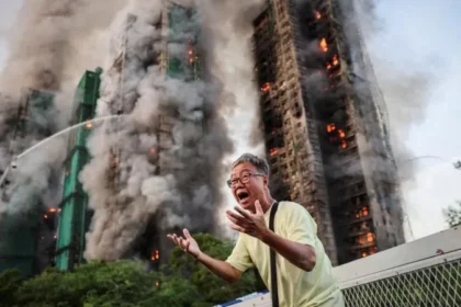 # Hong Kong Files First Criminal Charges in Deadly Wang Fuk Court Fire Case ## Major Legal Action After Deadly Housing Complex Fire Hong Kong authorities have filed the first criminal charges related to the devastating fire at Wang Fuk Court, a tragedy that claimed 168 lives and left thousands without homes. The incident, which occurred in November last year, became the city's deadliest fire disaster in more than seven decades. Prosecutors charged two companies and seven individuals with a total of 25 offences. The allegations include manslaughter, fraud, corruption, money laundering, tax evasion, and attempting to obstruct justice. ## Companies and Executives Face Manslaughter Charges Authorities charged engineering consultancy firm Will Power Architects and construction contractor Prestige Construction and Engineering with manslaughter. Several senior figures also face criminal charges. These include Prestige director Ho Kin-yip, Will Power director Wong Hap-yin, and registered inspector Ng Yeuk. Officials denied bail to all three men during a court hearing on Wednesday. Investigators believe serious safety failures contributed directly to the scale of the disaster. ## Investigation Reveals Critical Safety Failures An independent inquiry found multiple breaches of fire safety regulations throughout the housing complex. According to investigators, workers had disabled fire alarm systems in seven of the eight residential blocks during renovation work. The inquiry also found that contractors had covered windows with highly flammable foam boards. These materials likely accelerated the spread of the fire. Legal representatives leading the inquiry stated that nearly every major fire protection system failed when residents needed them most. Investigators also examined reports that workers frequently discarded lit cigarette butts around the construction site. ## Corruption and Fraud Allegations Expand the Case The case extends beyond fire safety concerns. Hong Kong's anti corruption agency filed additional charges against seven people, including Wong's wife and a close associate. Authorities allege that suspects manipulated the renovation tender process and falsified project supervision records. Investigators also accuse several individuals of laundering money connected to the project. Officials further claim that some suspects attempted to mislead investigators by hiding large amounts of cash and encouraging witnesses to provide false statements. ## More Arrests and Ongoing Investigations Police have arrested 35 people in connection with suspected manslaughter and fraud offences. Separately, anti corruption investigators detained 23 individuals, including contractors, consultants, and members of the building's owners' corporation. Authorities have not confirmed how many of those individuals remain under investigation or have since been released. The court has postponed the case until 2 September to allow investigators additional time to gather evidence and prepare further proceedings. ## Public Response and Media Scrutiny The disaster sparked widespread public concern across Hong Kong. Following the fire, authorities in both Hong Kong and Beijing urged media organizations and commentators to avoid spreading misinformation about the government's response. Days after the tragedy, national security police arrested local columnist Wong Kwok-ngon. Authorities accused him of publishing content intended to create hostility toward the government over its handling of the disaster. As investigations continue, the Wang Fuk Court fire remains one of the most significant public safety cases in Hong Kong's recent history.