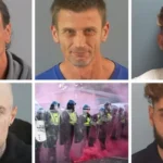 # Five Men Jailed After Violence Erupts at Henry Nowak Protest ## Protest Turns Violent Following Henry Nowak Case Five men have been sentenced to prison after taking part in violent disorder during a protest in Southampton linked to the death of Henry Nowak. The demonstration took place on 2 June after the release of police body camera footage showing the final moments of 18 year old Henry Nowak's life. Nowak died after being stabbed by Vickrum Digwa, who later received a life sentence with a minimum term of 21 years. The protest quickly escalated into violence. Officers faced attacks from members of the crowd, while objects were thrown at police lines. ## Police Officers Injured During Disorder The unrest left 12 police officers injured. A police dog also suffered injuries during the incident. Protesters threw wheelie bins, chairs, stones, and other objects at officers. Police worked to control the situation as tensions rose throughout the gathering. The court heard that the violence caused significant disruption and placed both officers and members of the public at risk. ## Court Hands Down Prison Sentences Southampton Crown Court sentenced five men for their involvement in the disorder. Daniel Frost, 44, from Southampton, received a prison sentence of two years and four months. The court heard he threw chairs and a bin into the road. He also carried a modified dog lead fitted with a metal carabiner that could be used as a weapon. Reece Robinson, 21, from Havant, was sentenced to two years in prison. Evidence showed he stood near the front of the crowd and threw stones or bricks towards police officers. Taylor Grundy, 22, from Gosport, was jailed for two and a half years for his role in the disorder. Andrew Summerhayes, 38, from Romsey, received the longest sentence of three years and two months. Prosecutors said he pushed a large bin into police officers during the violence. The court also noted his lengthy criminal record. Dillon Crawford, 29, from Southampton, was sentenced to three years in prison. ## Judge Condemns Actions of Protesters Judge William Mousley KC strongly criticised the behaviour of those involved. He described the incident as a serious outbreak of public disorder. The judge stated that hostility toward police officers played a major role in the violence. During sentencing, the court highlighted the dangerous nature of the attacks on officers and the impact the disorder had on the local community. The judge also pointed out that several defendants actively encouraged or participated in confrontational behaviour rather than leaving the scene when violence began. ## Impact on Community The case serves as a reminder of the consequences of violent public disorder. While peaceful protest remains a legal right, the court made clear that attacks on police officers and public violence will result in serious penalties. The prison sentences reflect the severity of the disorder and the injuries suffered by officers during the incident.