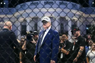 Federal investigators say they stopped a planned attack targeting a UFC event held at the White House. The plan allegedly involved drones loaded with explosives and a coordinated sniper setup aimed at creating panic during the large public gathering. Officials say the attack was intended to unfold in stages. The first step involved drone strikes near surrounding buildings. The second phase allegedly included snipers targeting people as crowds moved away in confusion. A final group would then try to enter secure areas near the White House. How Investigators Uncovered It Authorities discovered the plan through digital surveillance and intercepted communications. One key suspect was arrested in Ohio. Investigators accessed encrypted messages that linked him to other individuals involved in the planning. His mother reportedly alerted local authorities after noticing suspicious online activity and large firearms purchases. This tip helped law enforcement move quickly before the event took place. Suspects and Arrests Five people are now in custody according to officials. The arrests took place across several locations in the United States as part of a coordinated law enforcement operation. One suspect faces charges including conspiracy against the United States and attempted violence against a federal officer. Officials say more suspects may still be under investigation as the case develops. Online Activity and Motives Investigators say the group formed online earlier in 2026 through a social media chat group. Communication later moved to an encrypted messaging platform. Prosecutors describe the group as influenced by extreme ideological views and anti government sentiment. Messages referenced political grievances and broader frustrations about national issues. Officials say members discussed targeting high profile figures attending public events. Authorities also say the group spoke about triggering broader unrest through coordinated violence. Security Response and Investigation Security agencies worked together to stop the plan before any attack could occur. Officials described the situation as a serious threat but confirmed the event proceeded safely with strong protection measures in place. Investigations remain active. Authorities say additional suspects are still being tracked, and the case may expand as more digital evidence is analyzed.