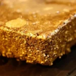 # Guinea Bans Raw Gold Exports to Strengthen Local Refining Industry Guinea has officially stopped the export of unrefined gold as part of a new strategy to strengthen its mining sector and increase economic growth. The government wants more gold to be processed inside the country before it reaches international markets. President Mamadi Doumbouya announced the decision after meeting with industrial and artisanal gold producers, traders, and buyers. The policy took effect immediately and aims to create jobs, increase revenue, and keep more value within Guinea's economy. ## Guinea Focuses on Local Gold Processing President Doumbouya said Guinea can no longer allow other countries to benefit from processing its raw materials. According to him, gold mined in Guinea should be refined locally before export. The government believes local processing will generate more employment opportunities and support industrial development. It also expects the move to increase earnings from the country's gold sector. ## New Refinery Near Completion in Conakry To support the new policy, Guinea is preparing to launch a major gold refinery in the capital city, Conakry. The facility is close to completion and will process gold produced across the country. Reports indicate the refinery can handle up to 250 tonnes of gold annually. This capacity is more than enough to process Guinea's current production levels. Authorities reported that Guinea exported over 22 tonnes of gold during the first quarter of this year. Once the refinery becomes fully operational, that gold will be processed domestically before reaching foreign markets. ## Mining Companies Face Strict Rules The government has warned mining companies and gold traders to follow the new regulations. Officials stated that companies violating the export ban could lose their operating licenses. Authorities may also terminate mining contracts if firms fail to comply with the directive. The government hopes these strict measures will ensure the success of the policy. ## Growing Trend Across Africa Guinea is not the first African country to introduce such reforms. Several nations have already taken steps to increase local processing of minerals and metals. Tanzania and Uganda currently ban the export of unprocessed minerals, including gold and copper. Ghana also plans to prohibit raw gold exports by 2030. Meanwhile, Zimbabwe, Africa's leading lithium producer, will ban lithium concentrate exports from 2027. The country aims to expand its battery materials industry and retain more economic value at home. ## Guinea's Important Role in Global Mining Guinea ranks as Africa's sixth largest gold producer, according to the World Gold Council. The country also holds the position of the world's largest producer of bauxite, the key raw material used to manufacture aluminium. With the new gold export policy, Guinea hopes to strengthen its industrial base, attract investment, and maximize profits from its natural resources. The move marks a significant step in the country's effort to build a stronger and more self-sufficient economy.