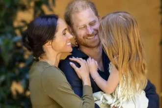 Harry and Meghan Share New Photos as Lilibet Turns Five Lilibet Celebrates Her Fifth Birthday Prince Harry and Meghan Markle marked their daughter Lilibet’s fifth birthday with new family photos. Meghan described her as their “dream girl” while sharing a warm message on social media. The couple continues to share occasional personal moments of their children, giving the public a glimpse into their family life. New Family Photos Shared The first photo shows Harry and Meghan smiling together while holding Lilibet in a close family embrace. The second image captures Lilibet outdoors in a garden. She appears relaxed and curious as she gently touches a flower. These images highlight a calm and private family setting focused on nature and togetherness. Meghan’s Birthday Message on Instagram Meghan posted the photos on Instagram and wrote, “Our dream girl. Happy 5th birthday, Lili.” She has previously shared similar moments of Lilibet, including a playful photo where she referred to her as “Mama’s little helper.” Family Life and Public Updates Lilibet is the couple’s second child and younger sister to Archie by two years. The Sussex family has gradually shared updates about their life outside royal duties. Recently, they celebrated their eighth wedding anniversary by sharing personal photographs from their wedding day. Netflix Projects and Archewell Work The couple’s production company, Archewell, is developing a feature film for Netflix. The project is based on a true story involving British troops during the Afghanistan conflict and adapts the book No Way Out by Major Adam Jowett. Their relationship with Netflix has shifted in recent years, moving from a full contract to a first look agreement, where Netflix gets the first option to review new projects. Recent Public Engagements Earlier this year, Harry and Meghan visited Australia in a private capacity. Their visit focused on Indigenous culture, sport, and community causes, along with a stop at the Australian War Memorial.