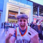 Knicks Bring Championship Fever Back to New York The New York Knicks have ignited a wave of excitement across New York City after reaching the NBA Finals for the first time since 1999. The team now leads the series 2 to 0 against the San Antonio Spurs, putting them just two wins away from a long awaited championship title. Game three takes place at Madison Square Garden, marking the first home game of the series. Fans across the city are treating it like a historic moment. High Security at Madison Square Garden Security has been significantly increased for the high profile game. Fans will face strict no bag rules along with airport like screening before entering the arena. US President Donald Trump is expected to attend the match, alongside New York Mayor Zohran Mamdani. The event has also attracted major celebrities including Timothée Chalamet, Ben Stiller, and Spike Lee. Authorities are preparing for heavy crowds and strong public attention due to the high stakes nature of the game. New York City Turns Orange and Blue The city has fully embraced the Knicks playoff run. Famous landmarks such as the Empire State Building and One World Trade Center have lit up in the team colors. Subway stations near Madison Square Garden now feature Knicks themed decorations. Local businesses across the five boroughs are offering special food deals, including orange and blue inspired snacks and desserts. Bars and public spaces are packed on game nights, with fans gathering to watch live broadcasts. Many streets near the arena have turned into unofficial celebration zones. Fans Celebrate a Historic Turnaround The Knicks success this season has surprised many supporters after years of poor performance. The team now stands one step away from a potential first championship since 1973. Even during away games in Texas, thousands of fans gathered in New York to celebrate wins. Some of these gatherings led to crowd control issues and several arrests as celebrations grew intense. Despite this, the atmosphere across the city remains highly energetic and focused on the possibility of a title win.