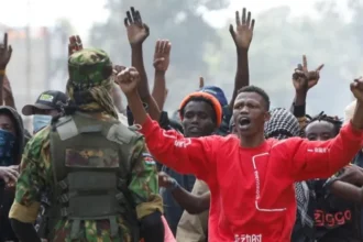 Protest Turns Violent in Nanyuki A protest in Nanyuki, a town in Kenya, turned deadly when clashes broke out between demonstrators and police over a planned Ebola isolation facility for US citizens. Witnesses reported that a man was shot during the unrest and later died. Authorities have not released an official statement on the incident. Earlier in the day, protesters gathered with Kenyan flags, placards, and even a symbolic coffin labeled Ebola. They demanded that the project be cancelled immediately. Subheading 2: Rising Tensions and Police Response Police used tear gas to disperse crowds as the demonstration escalated. Witnesses described chaos in the streets, with gunfire reported during the confrontation. According to journalists at the scene, one man was seen lying motionless after being shot. Local reports also say that similar protests in recent weeks ended in fatalities, increasing public anger and mistrust. Subheading 3: Concerns Over US Health Facility Plan The planned facility is expected to be a fifty bed isolation centre at a military base. It is designed to treat US citizens affected by an Ebola outbreak in Central Africa. Residents and protest leaders argue that the project lacks transparency and could put local communities at risk. Many fear possible disease exposure and say they were not properly consulted. Subheading 4: Legal Challenge and Public Reaction A court had already ordered a temporary halt to the project after a rights group raised concerns about public health risks. The case continues to fuel debate in the region. One protester said the project has created fear in the area and reduced visits to the county. Community members insist that their concerns must be addressed before any construction continues. Subheading 5: Background of the Ebola Situation The Ebola outbreak in parts of Central Africa has already led to hundreds of confirmed cases and over a hundred deaths. The proposed facility in Kenya is meant to support faster medical response for infected US nationals. A US official stated that Kenya was selected due to regional travel access and limited medical capacity in nearby airports.