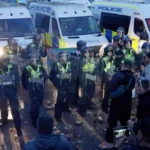 Two men jailed after violent disorder at Southampton protest over Henry Nowak murder Court sentences handed down after police injured in unrest Two men have been jailed after violent disorder broke out during a protest in Southampton linked to the murder of 18 year old Henry Nowak. Connor Bishop, 24, received a sentence of two years and eight months. Leon O’Leary, 41, was jailed for three years and one month. Both men admitted violent disorder in earlier court proceedings. The unrest took place on 2 June in the Portswood area. Police officers and a police dog were injured when objects were thrown at them during the escalation. Protest followed release of police footage The demonstration began after body camera footage was released showing Henry Nowak handcuffed while dying after being stabbed. The case relates to Vickrum Digwa, 23, who was convicted of murdering Nowak. He was sentenced to life in prison with a minimum term of 21 years. Digwa initially told police he was the victim of a racist attack, which led to confusion at the scene. Violence escalated outside police station and nearby streets The protest first gathered outside a city centre police station in Southampton. It later moved closer to the home of Digwa’s family. Authorities say the situation turned violent as crowds clashed with police. Officers were hit with thrown objects, including wheelie bins, chairs, and other debris. A total of 21 people have now been charged in connection with the disorder. Evidence presented in court CCTV and video footage were shown during sentencing. O’Leary was seen picking up a smoke grenade from the ground and throwing it toward police. He also admitted resisting arrest and possession of an offensive weapon after officers found a samurai sword at his home. He claimed it was a decorative item he had owned for years. During arrest, he reportedly took a defensive stance at the top of a staircase and threatened officers before being restrained with spray. Bishop was also identified in footage. He wore a black jumper with writing on the back and threw a traffic cone toward officers during the disorder. Investigation into police response The Independent Office for Police Conduct has launched an investigation into how police handled the initial incident and its aftermath. Henry Nowak’s family condemned the violence seen during the protest and called for calm following the events.