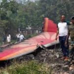 Air India Crash Investigation Still Ongoing One Year On as Final Report Delayed Investigation Update After One Year The investigation into the fatal Air India crash has not reached its final stage yet. The Indian aviation safety authority has confirmed that more time is needed before it can publish the final findings. The Aircraft Accident Investigation Bureau Aircraft Accident Investigation Bureau said it has made strong progress over the past year. Teams continue to study technical data, operational records, and human factors linked to the disaster. Officials also stated that the final report will only be released once all analysis is complete and required international review steps are finished. Crash Details and Human Loss The accident involved an Boeing 787 Dreamliner operated by Air India. It went down shortly after taking off from Ahmedabad on its way to London. The aircraft crashed about 6 kilometers from the airport. It struck a building used for medical staff housing at the Byramjee Jeejeebhoy Medical College and Civil Hospital and caused a major explosion. The disaster killed 241 people on board and 19 people on the ground. Among those who died were 169 Indian nationals and 53 British citizens. Only one passenger survived, Viswashkumar Ramesh from Leicester. Investigation Progress So Far The investigation team has reviewed flight recorder data, engine components, maintenance logs, and operational records. Officials say they have built a detailed technical picture of what happened, but the full analysis is still ongoing. They also confirmed that every aspect of the crash is being studied, including aircraft systems, human decisions, and organizational factors. Why the Report Is Delayed The authority explained that accident investigations focus on safety improvements rather than blame. Because of this, the process requires careful validation and international consultation before release. Officials added that they must complete all testing and cross check every piece of evidence before publishing final conclusions. Next Steps in the Investigation The final report will be shared only after all technical work is finished. Authorities say the goal is to improve aviation safety and prevent similar tragedies in the future.