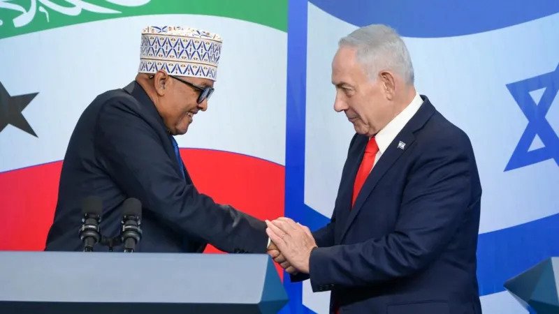 # Somaliland Opens Jerusalem Embassy After Israel Recognizes Its Independence ## Historic Step Strengthens Israel-Somaliland Relations Somaliland has officially opened an embassy in Jerusalem, marking a major milestone in its growing relationship with Israel. The move comes six months after Israel became the first country to recognize Somaliland as an independent nation. Somaliland President Abdirahman Mohamed Abdullahi inaugurated the diplomatic mission during his official visit to Israel. The embassy is located in a technology park in West Jerusalem and represents a new chapter in cooperation between the two governments. Israeli Prime Minister Benjamin Netanyahu welcomed the development and highlighted the strong ties between the two sides. He described the relationship as one built on shared history and mutual respect. ## Somalia Rejects the Move Somalia strongly criticized the opening of the embassy. The Somali government continues to view Somaliland as part of its national territory and does not recognize its claim to independence. Officials in Mogadishu stated that any foreign engagement with Somaliland undermines Somalia’s sovereignty. The government also renewed its opposition to international recognition of the breakaway region. Somaliland declared independence from Somalia in 1991. However, it has struggled to gain broad international recognition despite maintaining its own government, security forces, and institutions. ## International Reactions Remain Divided Israel’s decision to recognize Somaliland in December generated significant debate across the international community. Several countries and organizations voiced concern over the move. China, Turkey, Saudi Arabia, and the African Union were among those that criticized Israel’s recognition of Somaliland. Many governments continue to support Somalia’s territorial integrity. Despite the criticism, relations between Israel and Somaliland have continued to expand. Earlier this year, Israeli Foreign Minister Gideon Saar visited Hargeisa, the capital of Somaliland, to strengthen diplomatic cooperation. ## Why the Jerusalem Embassy Matters The location of Somaliland’s embassy has attracted international attention. Most foreign embassies in Israel operate from Tel Aviv rather than Jerusalem. Jerusalem remains one of the most sensitive issues in Middle East politics. Israel considers the entire city its capital. Palestinians, however, seek East Jerusalem as the capital of a future Palestinian state. Several countries have established embassies in Jerusalem in recent years, including Guatemala, Honduras, Kosovo, Papua New Guinea, Paraguay, and Fiji. Prime Minister Netanyahu praised Somaliland’s decision to establish its embassy in Jerusalem. He described the move as a sign of trust and friendship between the two nations. ## Palestinian Authority Condemns Embassy Opening The Palestinian Authority strongly opposed the opening of the Somaliland embassy in Jerusalem. Palestinian officials argued that the move violates international law and contradicts international resolutions concerning the city's status. The criticism reflects ongoing disagreements over Jerusalem's future and its role in regional diplomacy. ## Growing Diplomatic Partnership The embassy opening highlights the strengthening relationship between Israel and Somaliland. While the move has generated controversy, it also signals Somaliland’s efforts to gain broader international recognition. As diplomatic ties deepen, the development could influence future discussions about Somaliland’s status on the global stage.