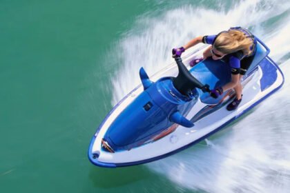 Jet Ski Speeding and Safety Concerns at Conwy Harbour Dangerous Speeds Reported on Water Jet skiers have been recorded travelling at extreme speeds in Conwy Harbour. Reports show some riders reaching up to 30 or 40 knots, which is around three to four times the local 10 knot speed limit. Authorities say children have been seen on board during these high speed runs. This has raised serious safety concerns for other water users in the area. Efforts to Control Reckless Activity Conwy council has installed CCTV cameras to monitor activity in the harbour. The system is meant to help identify those breaking speed rules. However, enforcement has faced challenges. Some riders have removed registration plates to avoid being identified. This has made it harder to take action against offenders. Harbour officials say this behaviour appears planned, as it suggests awareness of camera coverage in the area. High Risk Area Identified Officials have highlighted a narrow section of water between Deganwy and the navigation beacons as the most problematic zone. This area is heavily used and leaves little room for error at high speed. Clear warning signs are placed at key points around the harbour, including slipways and marina exits. Yellow marker buoys also indicate the speed restricted zone. Safety Concerns Raised by Harbour Authorities The Harbour Master has described repeated cases of dangerous behaviour in recent months. He stressed that only a small number of users are responsible, but their actions put others at risk. Authorities say they are still working on gathering stronger evidence. They want to link speeding incidents with vessel launch points before taking formal action. Steps Being Taken Officials are improving warning signage to make speed limits clearer. They are also working with CCTV teams to record incidents in real time. Plans for further enforcement are still in development as authorities try to close gaps that allow offenders to avoid penalties.