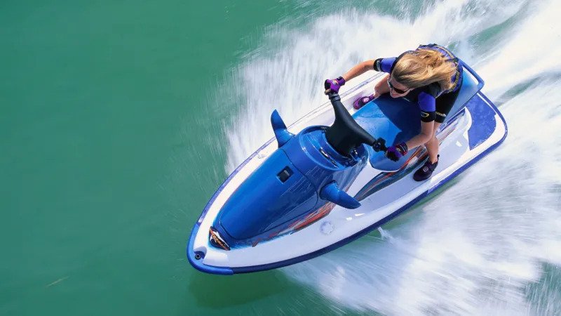 Jet Ski Speeding and Safety Concerns at Conwy Harbour Dangerous Speeds Reported on Water Jet skiers have been recorded travelling at extreme speeds in Conwy Harbour. Reports show some riders reaching up to 30 or 40 knots, which is around three to four times the local 10 knot speed limit. Authorities say children have been seen on board during these high speed runs. This has raised serious safety concerns for other water users in the area. Efforts to Control Reckless Activity Conwy council has installed CCTV cameras to monitor activity in the harbour. The system is meant to help identify those breaking speed rules. However, enforcement has faced challenges. Some riders have removed registration plates to avoid being identified. This has made it harder to take action against offenders. Harbour officials say this behaviour appears planned, as it suggests awareness of camera coverage in the area. High Risk Area Identified Officials have highlighted a narrow section of water between Deganwy and the navigation beacons as the most problematic zone. This area is heavily used and leaves little room for error at high speed. Clear warning signs are placed at key points around the harbour, including slipways and marina exits. Yellow marker buoys also indicate the speed restricted zone. Safety Concerns Raised by Harbour Authorities The Harbour Master has described repeated cases of dangerous behaviour in recent months. He stressed that only a small number of users are responsible, but their actions put others at risk. Authorities say they are still working on gathering stronger evidence. They want to link speeding incidents with vessel launch points before taking formal action. Steps Being Taken Officials are improving warning signage to make speed limits clearer. They are also working with CCTV teams to record incidents in real time. Plans for further enforcement are still in development as authorities try to close gaps that allow offenders to avoid penalties.