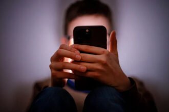 The UK government has asked major tech companies to improve safety controls on smartphones used by children. The main goal is to stop minors from taking, sending, or viewing nude images on their devices. Keir Starmer said companies must act quickly by using existing tools or updating their systems. The request targets major platforms such as Apple and Google. Government Push for Stronger Child Safety The government wants tech firms to activate stronger protections for children within three months. These protections should work across smartphones and tablets used in the UK. If companies fail to comply, new laws may follow. These laws could include financial penalties. In serious cases, companies could face legal responsibility. Officials also said the rules would apply to both new and already sold devices. Adults would not be affected if they verify their age correctly. How the System Could Work Some safety tools already exist on modern devices. Apple offers a Communication Safety feature. It can detect nude images in messages and warn children before they send or receive them. It works in apps like Messages, AirDrop, and FaceTime. Google Messages can blur sensitive content for users under parental supervision. It also reduces exposure to harmful images on Android devices. Some companies are also testing artificial intelligence tools that detect and block explicit images directly on devices. The government has highlighted these tools as possible solutions for wider use. Privacy and Safety Concerns Not everyone agrees on how far these controls should go. Some experts worry that stronger restrictions could affect user privacy. They believe age checks for adults or system wide scanning could create new risks. Others argue that stronger action is necessary to protect children from grooming and sextortion online. Existing Laws and Ongoing Debate The UK already has online safety rules under the Online Safety Act. These rules require platforms to take responsibility for harmful content. Even with these laws, campaigners say more action is needed. They believe children are still exposed to harmful content through messaging apps and social platforms.