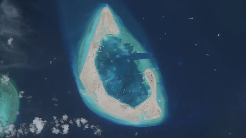 A rapidly changing landscape in the South China Sea Antelope Reef, located in the north west of the South China Sea, has changed beyond recognition. Until recently, it was mostly underwater and barely visible above the waves. Now it has become a newly formed island stretching around six square kilometres, built in just half a year. Satellite images show a bright white sand formation shaped like a crescent. Small structures have already appeared on one side. Inside the lagoon, a large number of vessels are operating, believed to be powerful dredging ships used to reshape the seabed. Massive dredging operations reshape reefs China operates one of the largest dredging fleets in the world. Some of these ships can move around 6,000 cubic metres of sand per hour. That is enough material to fill two Olympic sized swimming pools in a single hour. Millions of tonnes of sand have been extracted from the seabed to create solid ground. The speed of this transformation is among the fastest recorded for such projects. Regional powers expand their presence China is not acting alone in reshaping reefs in the region. Vietnam has also begun strengthening and expanding reefs under its control in response to earlier Chinese projects. The Philippines and other claimants are also carrying out smaller scale construction activities. These developments reflect growing competition over territory in the South China Sea. Disputed waters and rising tensions The South China Sea is claimed by China, Taiwan, Vietnam, the Philippines, Malaysia, and Brunei. Most of the reefs involved were once submerged and had no permanent population. China took control of the Paracel Islands in 1974 after a conflict with South Vietnamese forces. Since then, it has expanded its presence significantly across the region. In recent years, China has built artificial islands on reefs such as Mischief, Fiery Cross, and Subi in the Spratly Islands. These islands now support airstrips and military facilities. Military concerns and strategic messaging China’s coastguard and maritime militia regularly patrol within its claimed nine dash line boundary. This has increased tensions with neighbouring countries, especially the Philippines, where several confrontations have occurred at sea. The shape and construction style of Antelope Reef suggests the possibility of future military use, including a potential runway. However, China already operates nearby airstrips on Woody Island and Hainan Island. Analysts suggest the latest expansion may be less about immediate military need and more about signalling control over the region