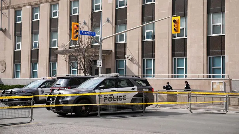 Toronto police officer killed during a raid linked to a consulate shooting investigation in Toronto, with one suspect still at large and police continuing the manhunt.