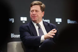 Donald Trump stopped the planned confirmation hearing for his nominee Jay Clayton. The hearing was set to take place before the United States Senate Select Committee on Intelligence. Clayton was expected to begin the approval process to become Director of National Intelligence. That role oversees the country intelligence agencies and advises the president on national security. Reason Behind the Decision Trump said the hearing should not move forward because Congress has not acted on surveillance legislation. He pointed to issues with the Foreign Intelligence Surveillance law, which governs how intelligence agencies collect data from communication companies. He also linked the situation to disagreement over a separate voting bill. He said he would not support the surveillance law unless changes connected to voting rules were included. This move created tension because the two issues are normally handled separately in Congress. Political Reactions Senator Tom Cotton said the hearing was postponed and expressed regret over the delay. He said Clayton is qualified and ready for the role, and he expects the process to continue soon. Senator Mark Warner criticized the decision. He said national security should not depend on social media statements and warned that intelligence decisions should stay separate from political bargaining. What Happens Next Clayton remains the nominee for Director of National Intelligence. The Senate has not set a new date for the hearing. The position oversees 18 intelligence agencies and serves as the main adviser to the president on security matters. The current acting intelligence chief, Bill Pulte, will continue in the role until a permanent leader is confirmed. The previous director, Tulsi Gabbard, is expected to leave office on 30 June.