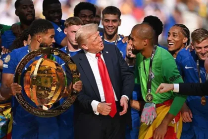 Trump expected at World Cup final in New Jersey United States president Donald Trump is expected to attend the World Cup final scheduled for 19 July at MetLife Stadium in New Jersey. FIFA president Gianni Infantino confirmed that Trump will be present for the match and will take part in the trophy presentation after the final. FIFA confirms joint trophy presentation plan FIFA World Cup 2026 president Gianni Infantino said he will stand alongside Trump during the trophy ceremony. He stated that both will appear together to hand the trophy to the winning team. The tournament is jointly hosted by the United States, Mexico, and Canada, with most matches taking place in the United States. Infantino described a close working relationship with Trump and said coordination for the final ceremony is already in place. The final match will mark the conclusion of a tournament that began on 11 June. Trump’s recent public appearances at major sports events Trump has not yet attended any World Cup matches during the tournament. However, he has appeared at other major sporting events in recent weeks. He attended a UFC event held at the White House and later went to an NBA Finals game in New York, where he received a mixed reaction from the crowd. Officials working with the White House World Cup task force said Trump prefers flexible scheduling and often makes late decisions about attending live events. Context from previous trophy ceremony at MetLife Stadium During a previous event at MetLife Stadium, Trump handed over a trophy after a Club World Cup final and briefly remained on stage. That moment caused confusion among some players, including Chelsea captain Reece James, who later noted that he expected Trump to leave the stage after the presentation.