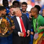 # Trump to Attend FIFA World Cup Final and Present Trophy Alongside FIFA President United States President Donald Trump is expected to attend the FIFA World Cup Final on July 19 at MetLife Stadium in New Jersey. FIFA President Gianni Infantino confirmed that both leaders will take part in the trophy presentation ceremony after the match. The 2026 FIFA World Cup has attracted global attention since it began on June 11. The tournament is being hosted by the United States, Canada, and Mexico, with the United States staging most of the matches. ## Trump Expected at the Biggest Match of the Tournament Gianni Infantino recently shared that he plans to attend the World Cup final with President Trump. He also stated that they will present the championship trophy to the winning team together. Although Trump has not attended a World Cup match so far, officials say his busy schedule has limited his availability. However, his appearance at the final would place him at one of the most watched sporting events in the world. ## Strong Relationship Between Trump and FIFA Over the past few years, Trump and Infantino have maintained a close working relationship. Their cooperation has become more visible as the United States prepares to host major international football events. The World Cup final will provide another opportunity for both figures to appear together on a global stage. Millions of football fans around the world are expected to watch the trophy presentation ceremony. ## Previous Sports Appearances Drew Attention Trump has attended several major sporting events recently, including UFC competitions and the NBA Finals. His appearances have often generated significant media coverage and public reaction. Last year, Trump also attended the FIFA Club World Cup final at MetLife Stadium. During the trophy ceremony, he remained on stage after presenting the trophy. The unexpected moment attracted attention from fans and players alike. Chelsea captain Reece James later revealed that organizers had expected Trump to leave the stage after the presentation. Instead, he chose to stay during the celebrations. ## Global Spotlight on the World Cup Final The FIFA World Cup Final is expected to become one of the largest sporting events of 2026. Trump's planned attendance adds another layer of interest to an already historic occasion. Football fans across the globe will now wait to see which nation reaches the final and lifts the famous World Cup trophy in New Jersey.
